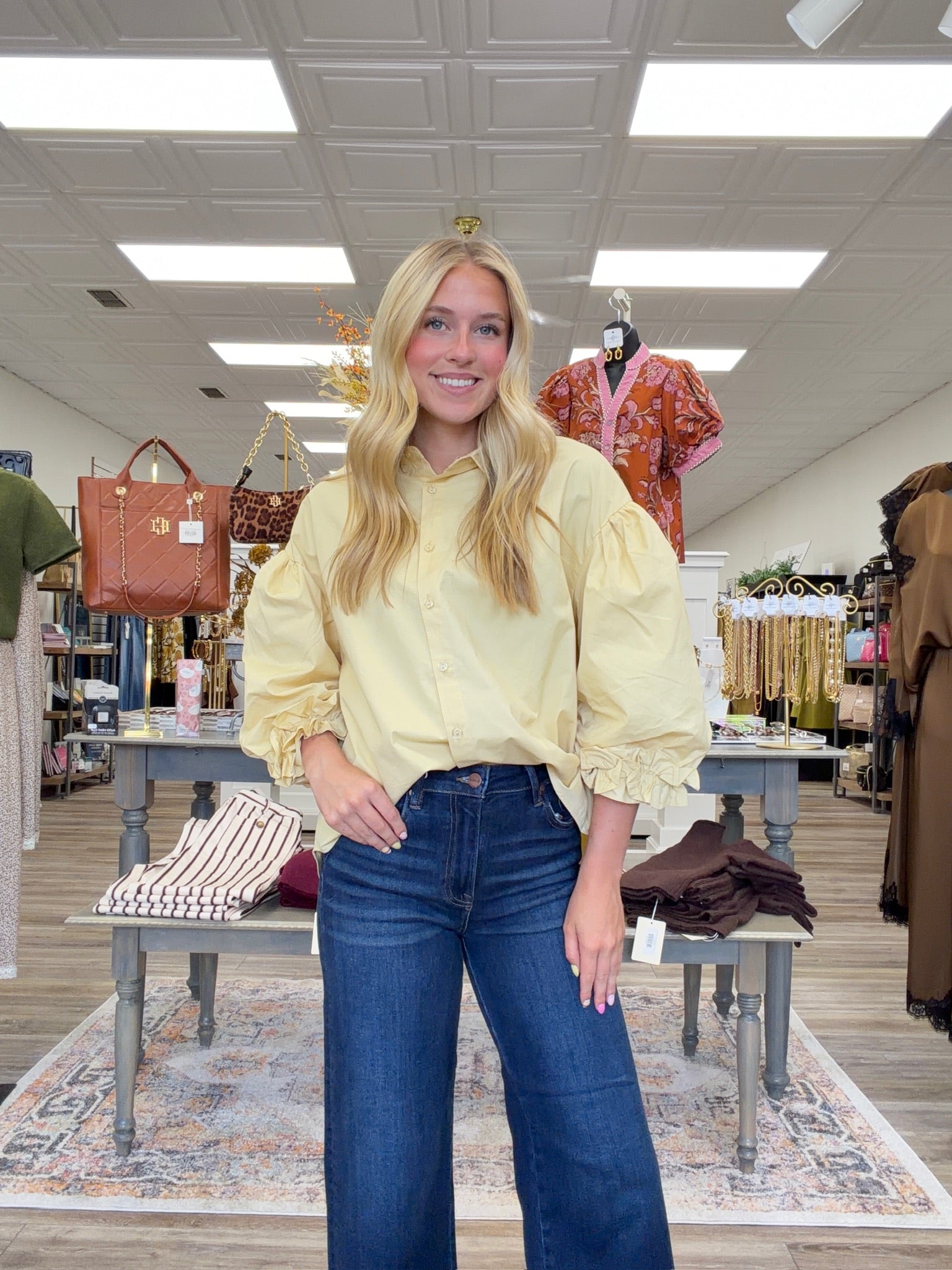 The Eloise blouse - a butter-yellow button-front blouse featuring an oversized collar, dramatic balloon sleeves, and gathered ruffle cuffs.