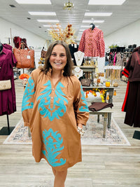 The Jolene dress - This camel-brown dress features beautiful turquoise appliqué detailing on the front, 3:4 sleeve