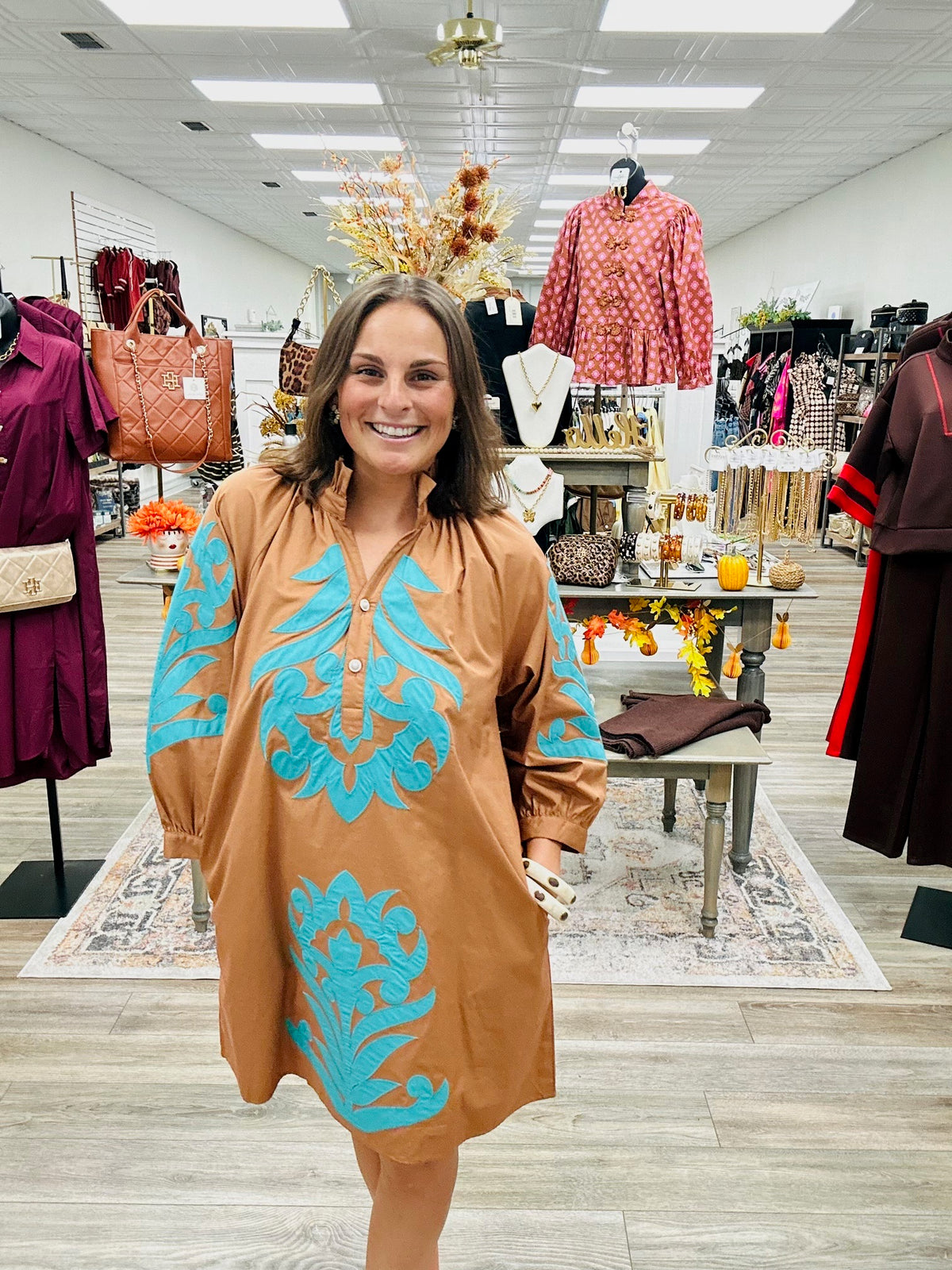The Jolene dress - This camel-brown dress features beautiful turquoise appliqué detailing on the front, 3:4 sleeve