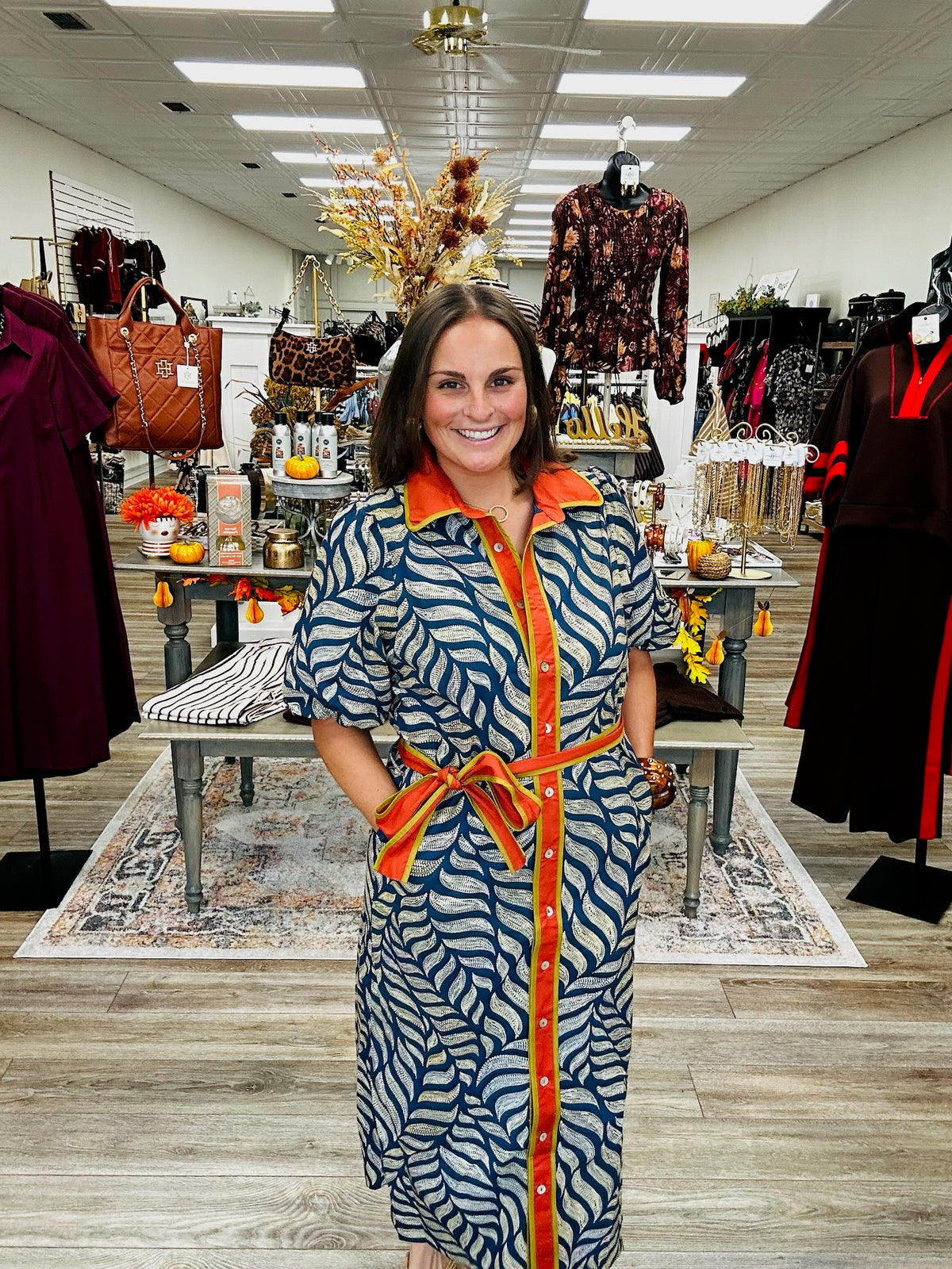 Golden Fern dress - navy leaf-print dress featuring a bold rust-orange collar and button-front trim with olive green accents