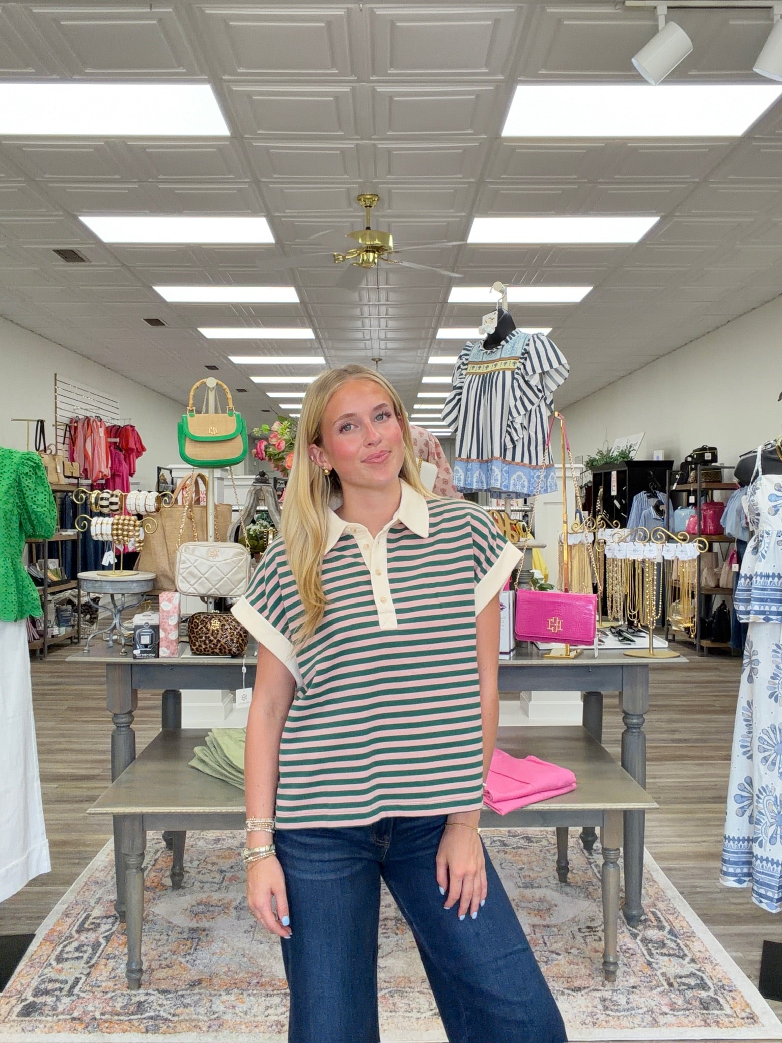 Coastal stripe polo - Short-sleeve striped polo top with dark green and soft pink horizontal stripes, featuring a cream collar and button placket