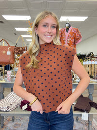 The cinnamon Spice Dot Sweater top features structured cap sleeves, navy polka dot pattern and a relaxed fit.