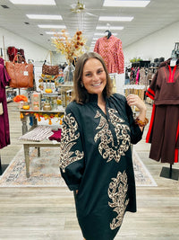 The Savannah Luxe Leopard Embroidered Tunic features a classic black fabric with leopard- inspired embroidered detailing. Ruffled mock neckline and three- quarter puff sleeves.