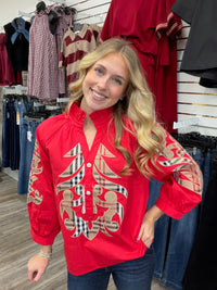 Crimson Plaid Statement Blouse - vibrant red long-sleeve blouse featuring bold plaid appliqué embroidery, a ruffled collar, and button-front detailing