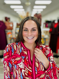 Painted Petals Top — A vibrant floral top featuring rich burgundy, pink, blue, and warm neutral tones