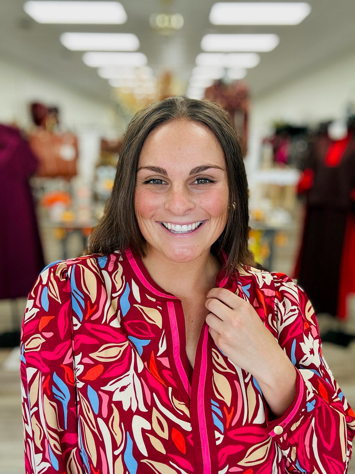 Painted Petals Top — A vibrant floral top featuring rich burgundy, pink, blue, and warm neutral tones