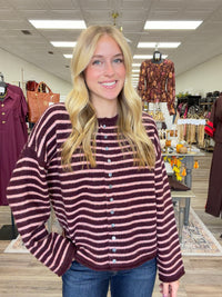 The Blush & Burgundy Cozy Stripe Henley Sweater. This top features ultra soft fuzzy knit fabric, a relaxed, comfortable fit and lightweight warmth for layering.