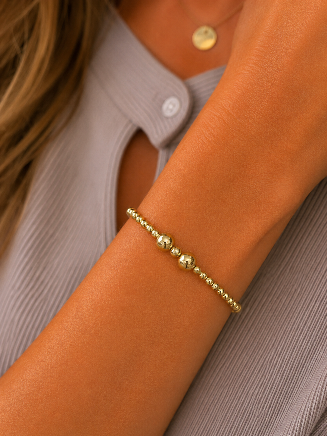 Stretch beaded stackable gold bracelet with small and larger beads– steel 18 karat gold overlay