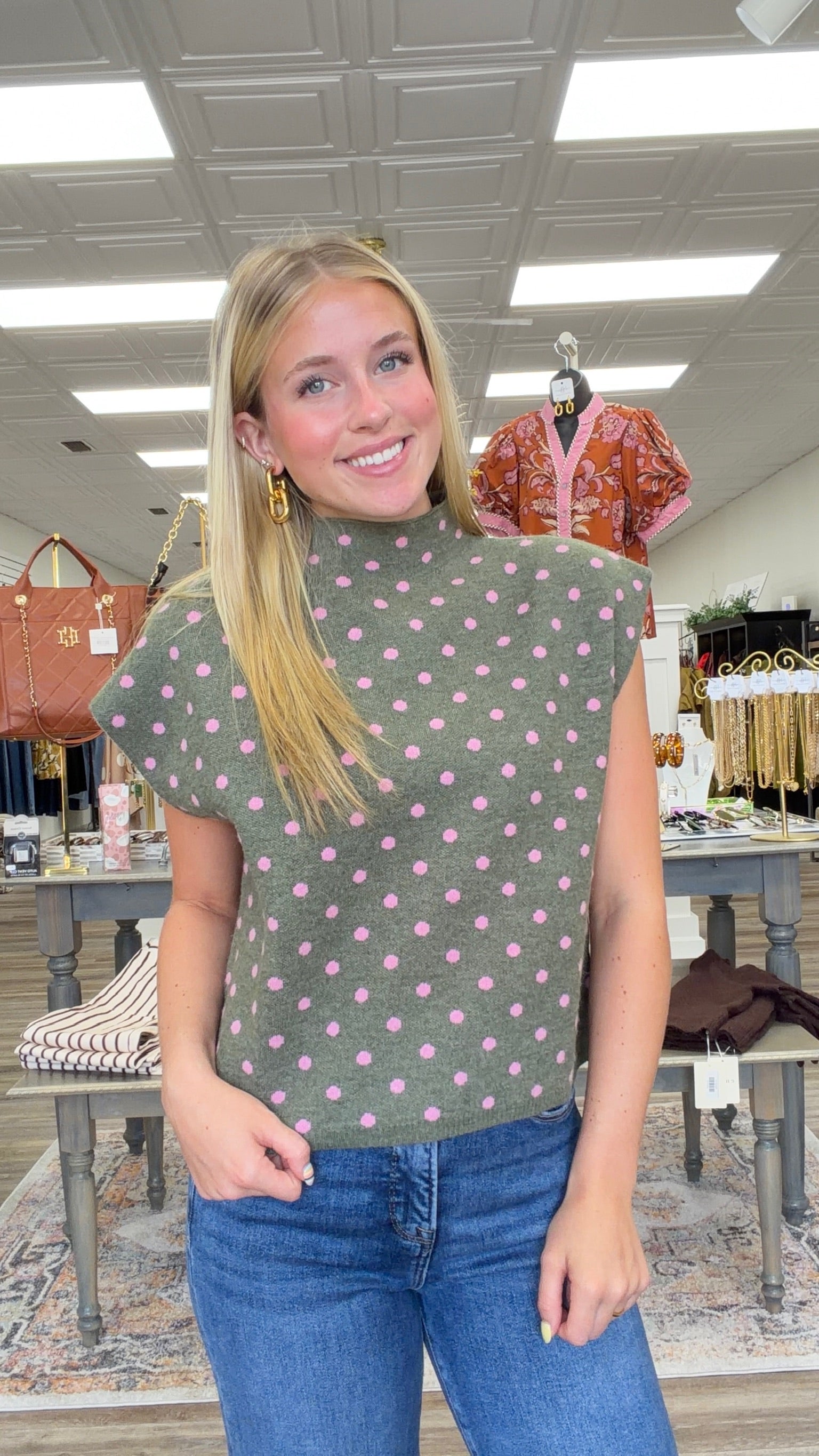 The Evie sweater - Olive knit short-sleeve sweater top with pink polka dots, featuring a high crew neckline, relaxed boxy fit, and lightweight sweater-knit construction. Entro