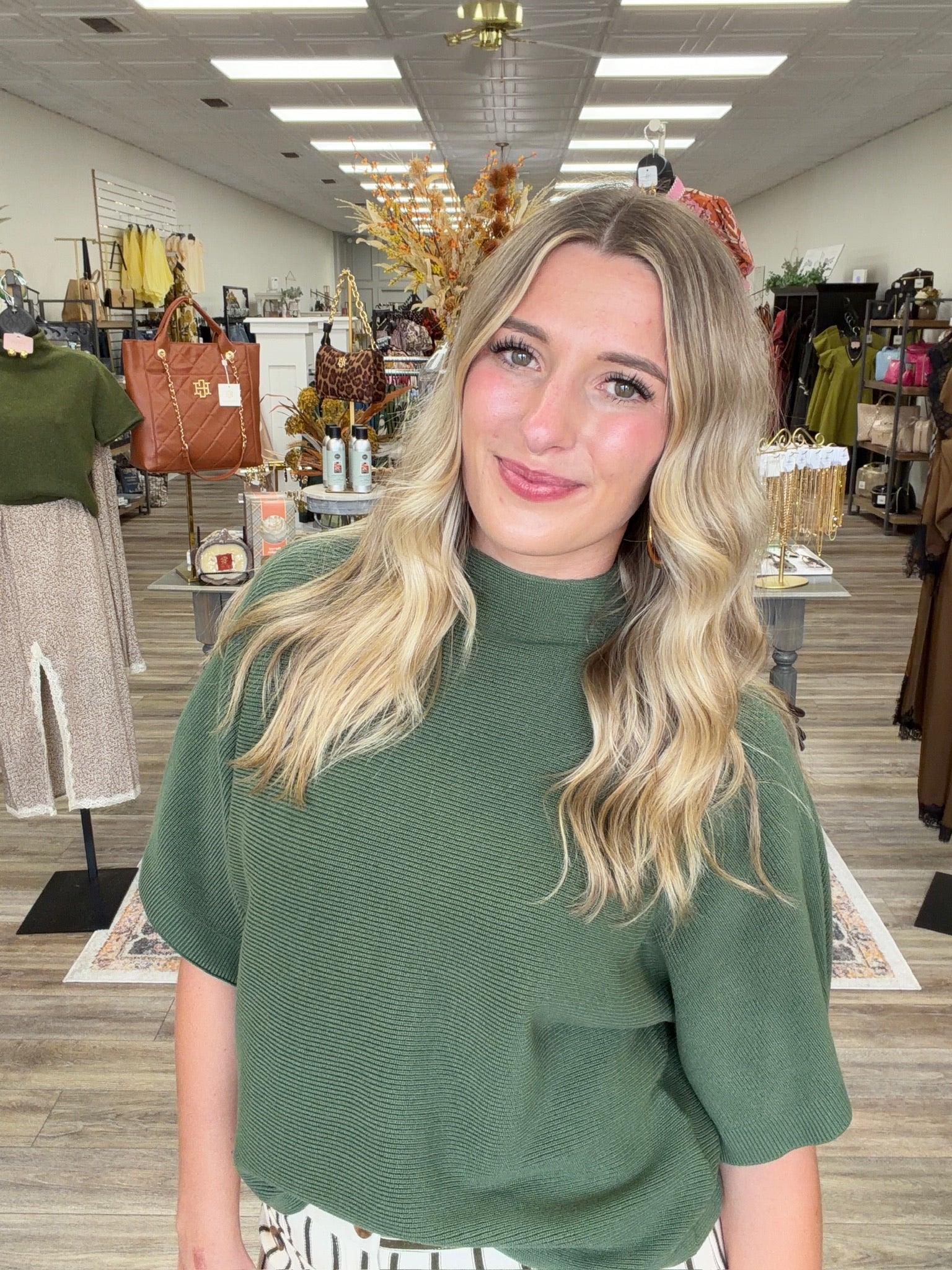 The Nora sweater-  A olive ribbed-knit mock-neck top featuring a relaxed oversized silhouette, wide elbow-length sleeves, Entro