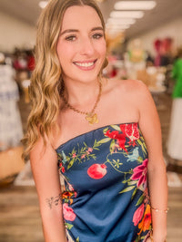 The  Valencia floral dress - A strapless navy-blue satin midi dress featuring a fitted bodice that flows into a softly flared skirt.