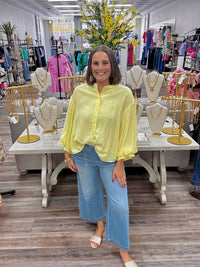 The Joy blouse - A butter-yellow collarless blouse featuring voluminous bishop sleeves, a minimalist button-front placket, and an easy oversized silhouette.