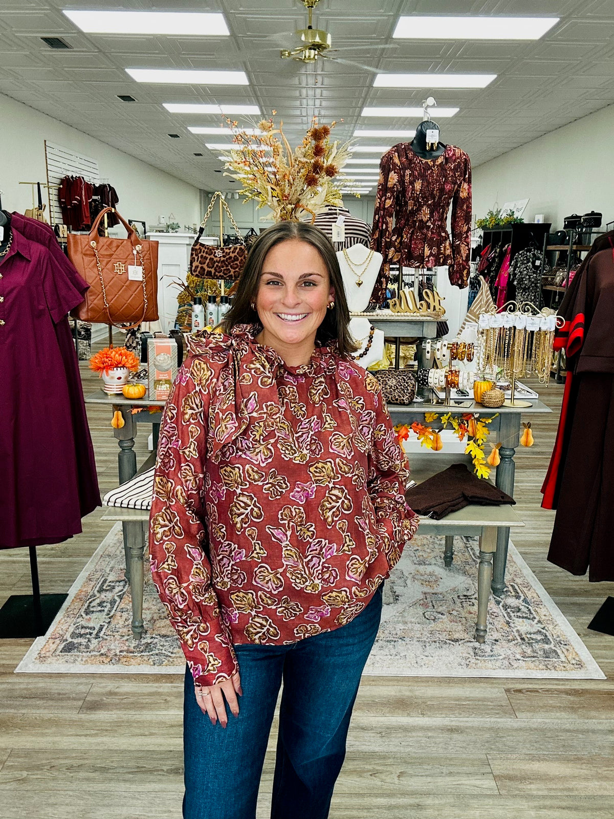 Autumn Romance Blouse- Brick colored blouse with fall floral print, featuring a tie neckline and thin long sleeves.