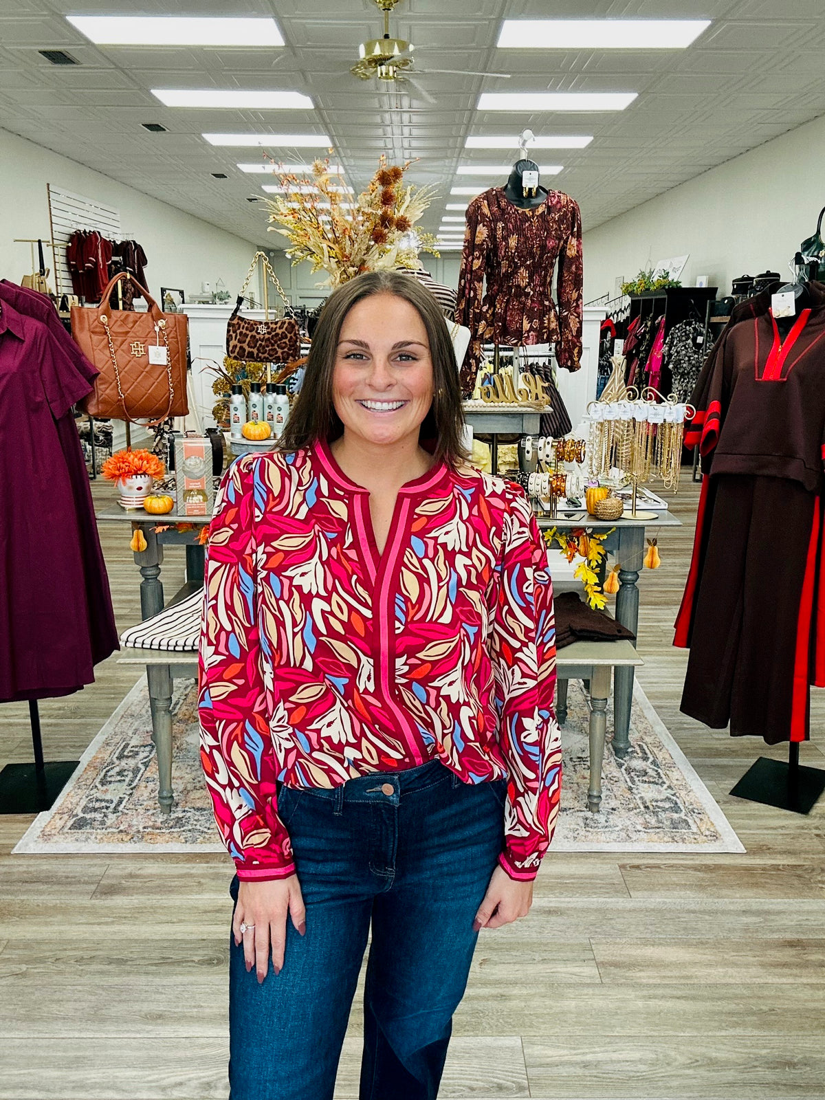 Painted Petals Top — A vibrant floral top featuring rich burgundy, pink, blue, and warm neutral tones