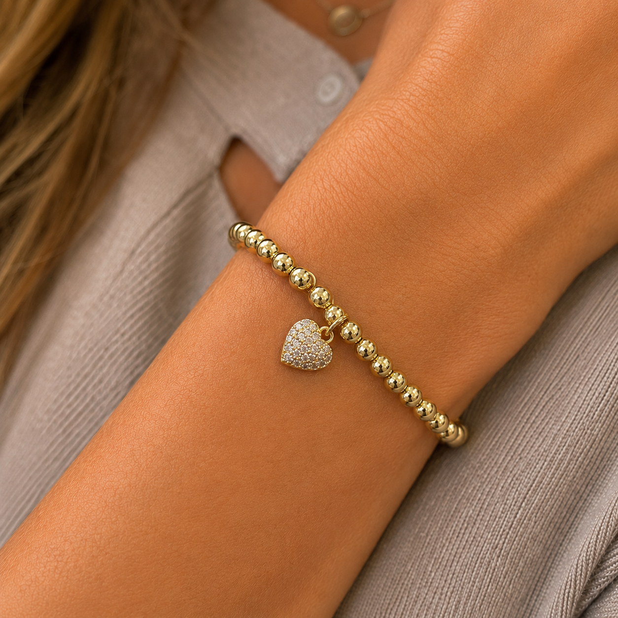 Stretch beaded gold stackable bracelet with cz heart charm accent- steel 18 karat gold overlay