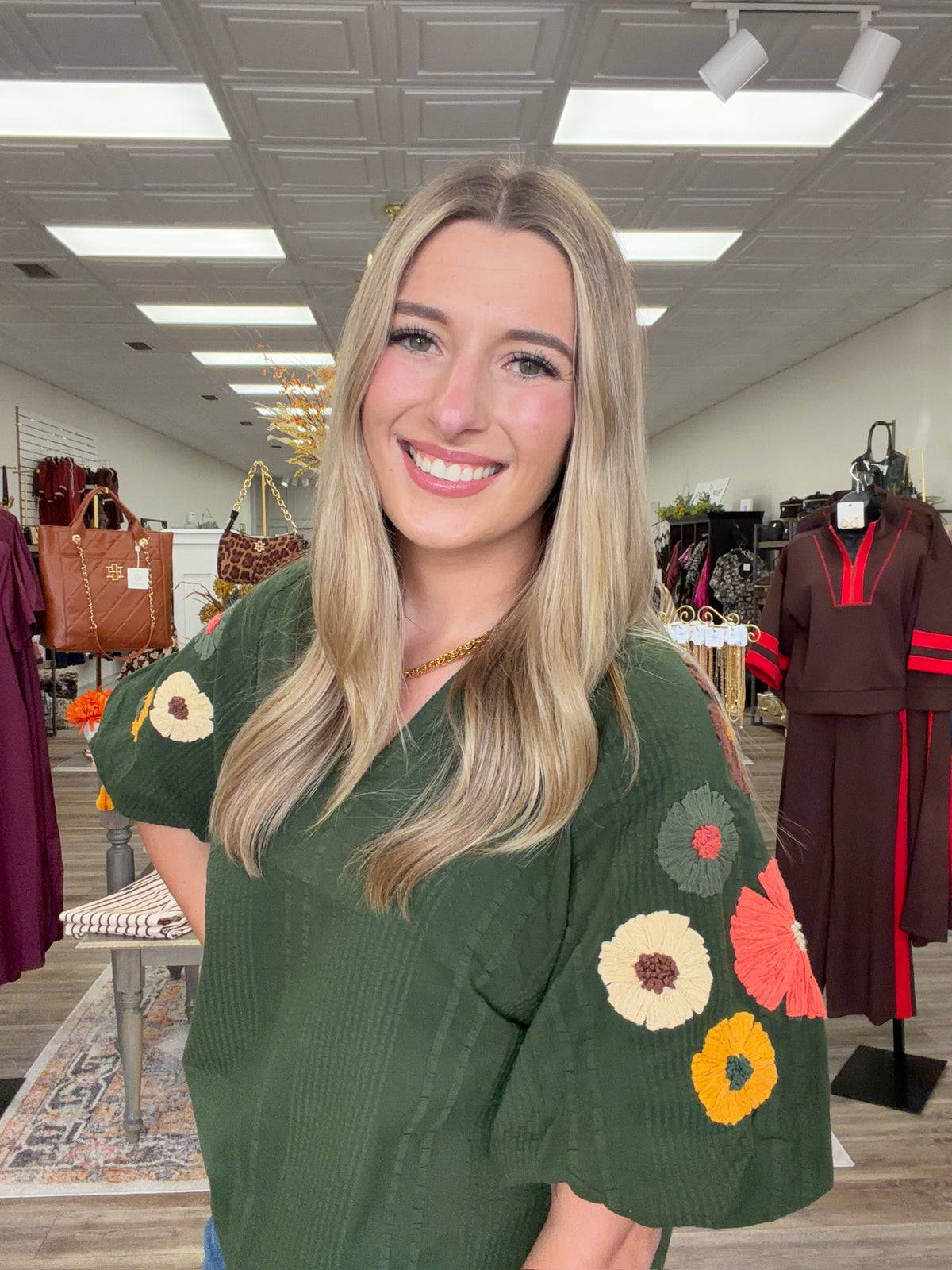 Fall meadow top - rich forest-green textured top featuring statement puff sleeves adorned with colorful dimensional floral details