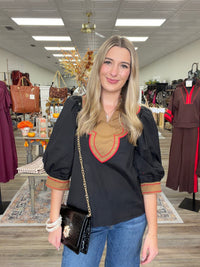 Saddle & Scarlet Blouse - chic black puff-sleeve top featuring a camel scalloped bib collar with vibrant red embroidered trim and matching statement cuffs