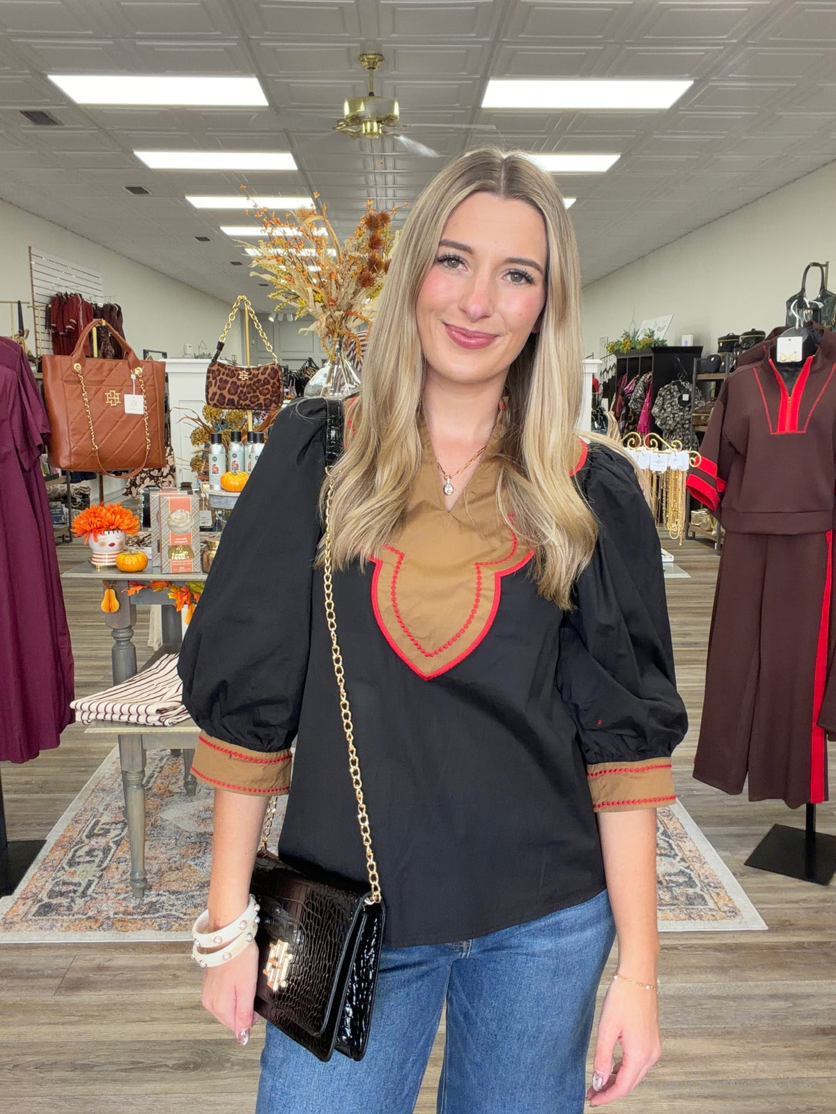 Saddle & Scarlet Blouse - chic black puff-sleeve top featuring a camel scalloped bib collar with vibrant red embroidered trim and matching statement cuffs
