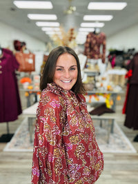 Autumn Romance Blouse- Brick colored blouse with fall floral print, featuring a tie neckline and thin long sleeves.