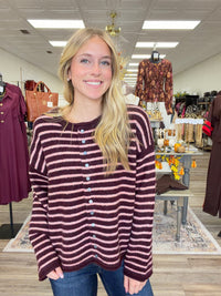 The Blush & Burgundy Cozy Stripe Henley Sweater. This top features ultra soft fuzzy knit fabric, a relaxed, comfortable fit and lightweight warmth for layering.
