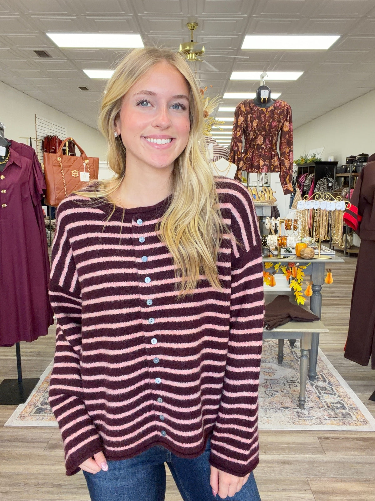 The Blush & Burgundy Cozy Stripe Henley Sweater. This top features ultra soft fuzzy knit fabric, a relaxed, comfortable fit and lightweight warmth for layering.