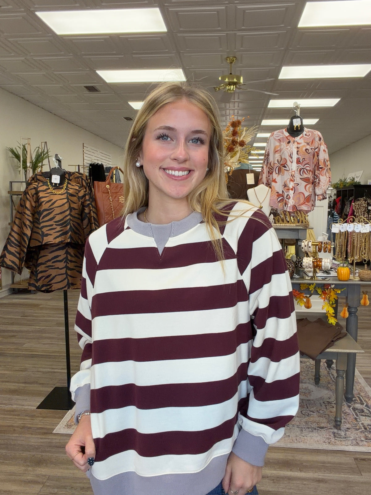 Harvest Lane Stripe Top - soft burgundy and ivory striped pullover features a relaxed fit, split neckline, gray ribbed trim, and decorative buttons along the side
