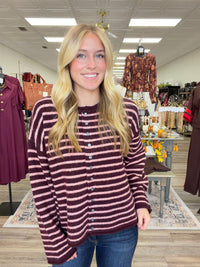 The Blush & Burgundy Cozy Stripe Henley Sweater. This top features ultra soft fuzzy knit fabric, a relaxed, comfortable fit and lightweight warmth for layering.
