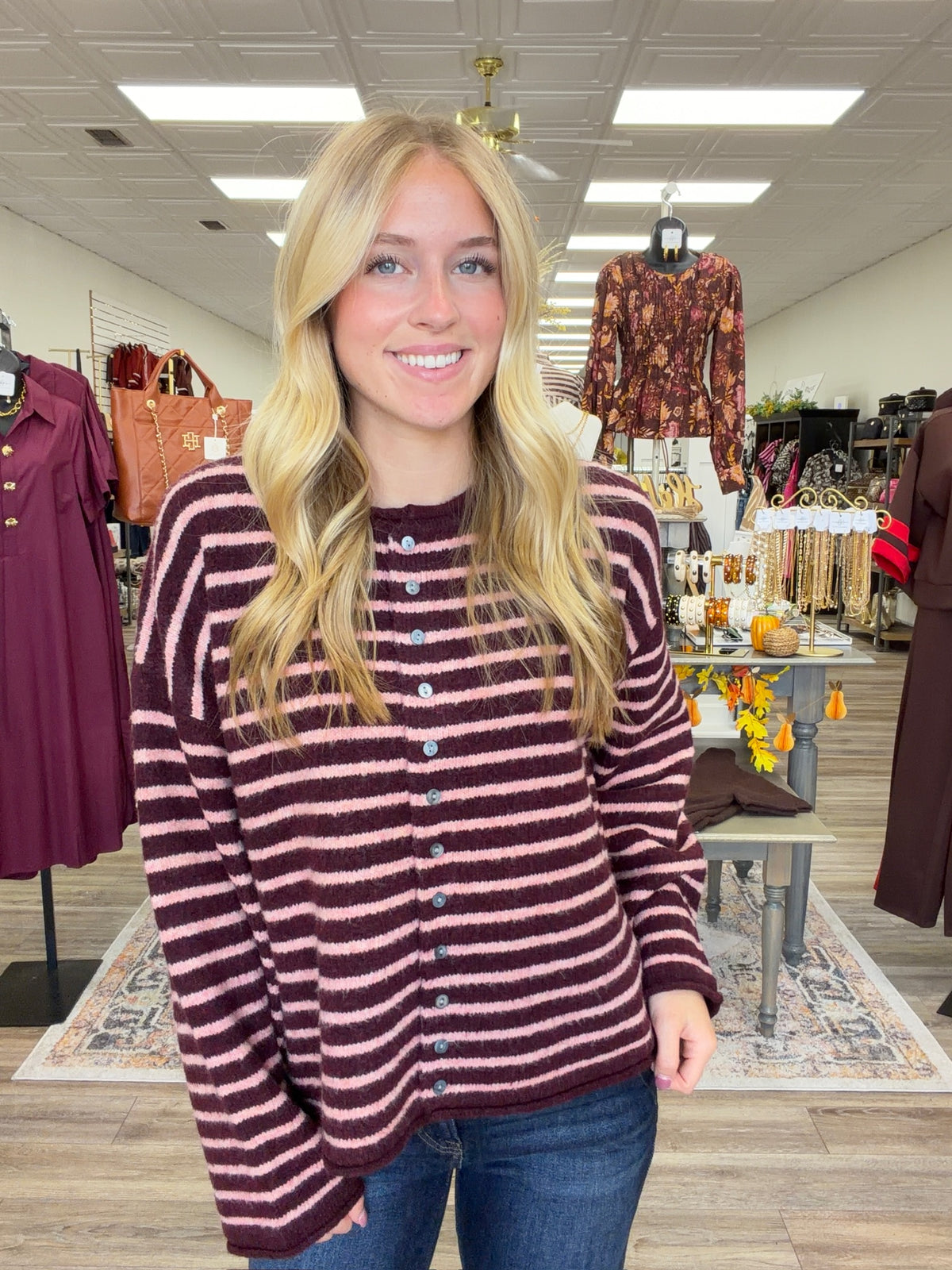 The Blush & Burgundy Cozy Stripe Henley Sweater. This top features ultra soft fuzzy knit fabric, a relaxed, comfortable fit and lightweight warmth for layering.