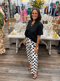 The Sadie pants - high-waisted pants featuring a bold black-and-white polka dot print with a relaxed wide-leg fit, a button-front closure and oversized front patch pockets