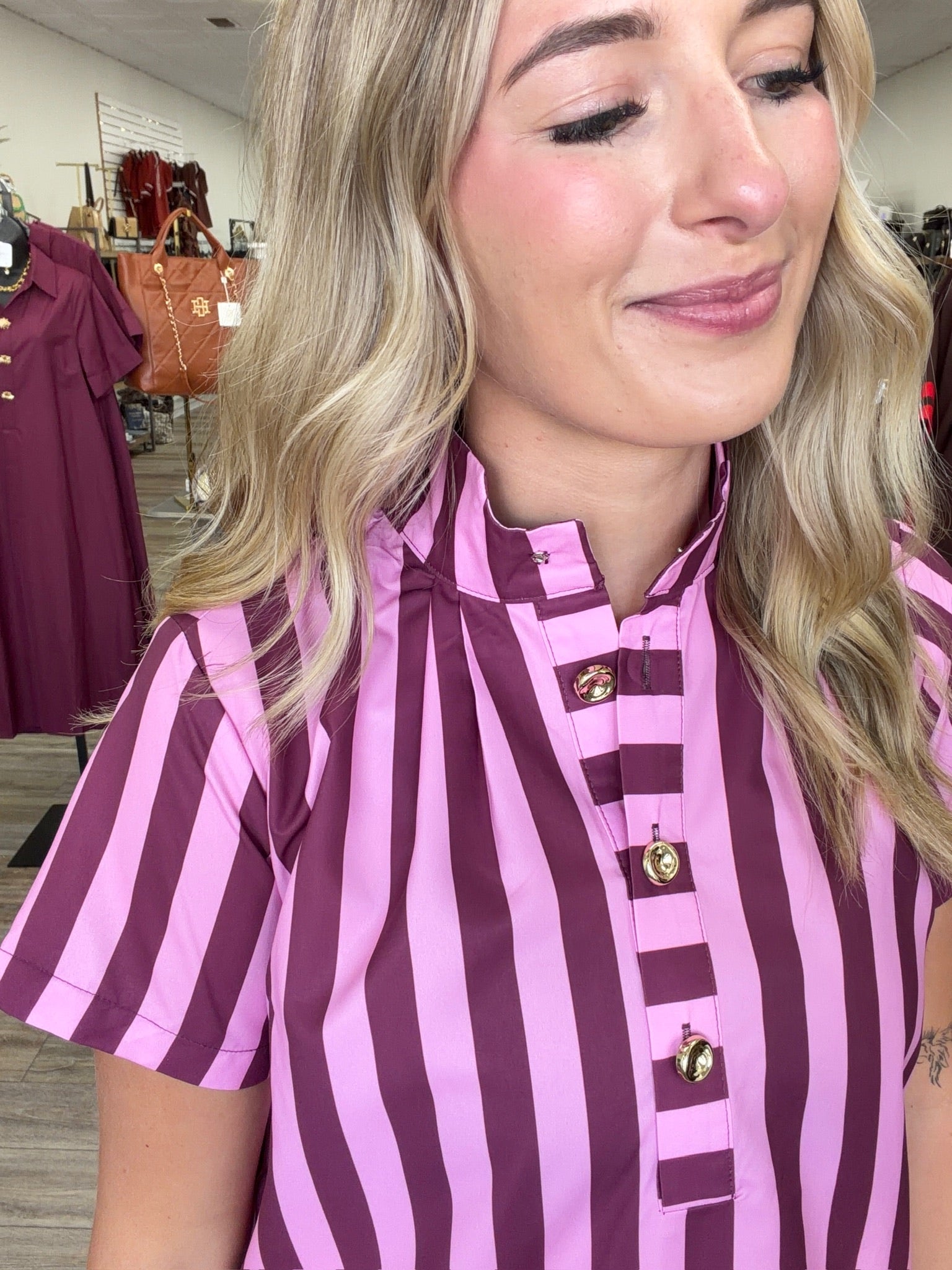 Raspberry Rush Dress – bold pink and burgundy striped dress featuring a relaxed silhouette, collared neckline, and chic gold button detailing.