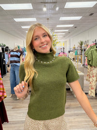 Olive Grove Luxe Knit Top. Ultra-soft moss green knit top, featuring a relaxed mock neckline, short sleeves, and a flattering easy-fit silhouette. -Entro