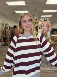 Harvest Lane Stripe Top - soft burgundy and ivory striped pullover features a relaxed fit, split neckline, gray ribbed trim, and decorative buttons along the side