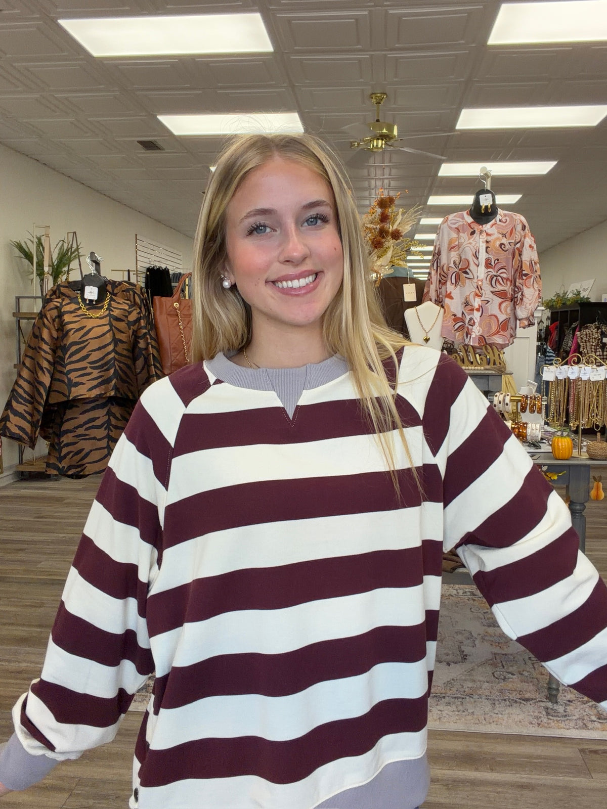 Harvest Lane Stripe Top - soft burgundy and ivory striped pullover features a relaxed fit, split neckline, gray ribbed trim, and decorative buttons along the side