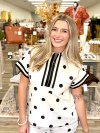 Dot to Dot Lounge Set - chic cream-and-black polka dot two-piece set featuring a sporty half-zip top, striped trim, and matching wide-leg pants.