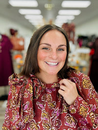 Autumn Romance Blouse- Brick colored blouse with fall floral print, featuring a tie neckline and thin long sleeves.