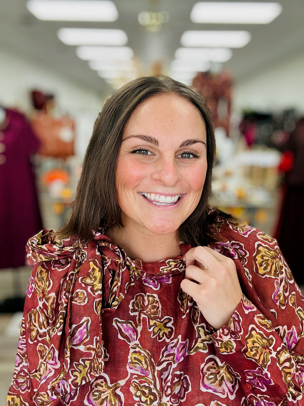 Autumn Romance Blouse- Brick colored blouse with fall floral print, featuring a tie neckline and thin long sleeves.