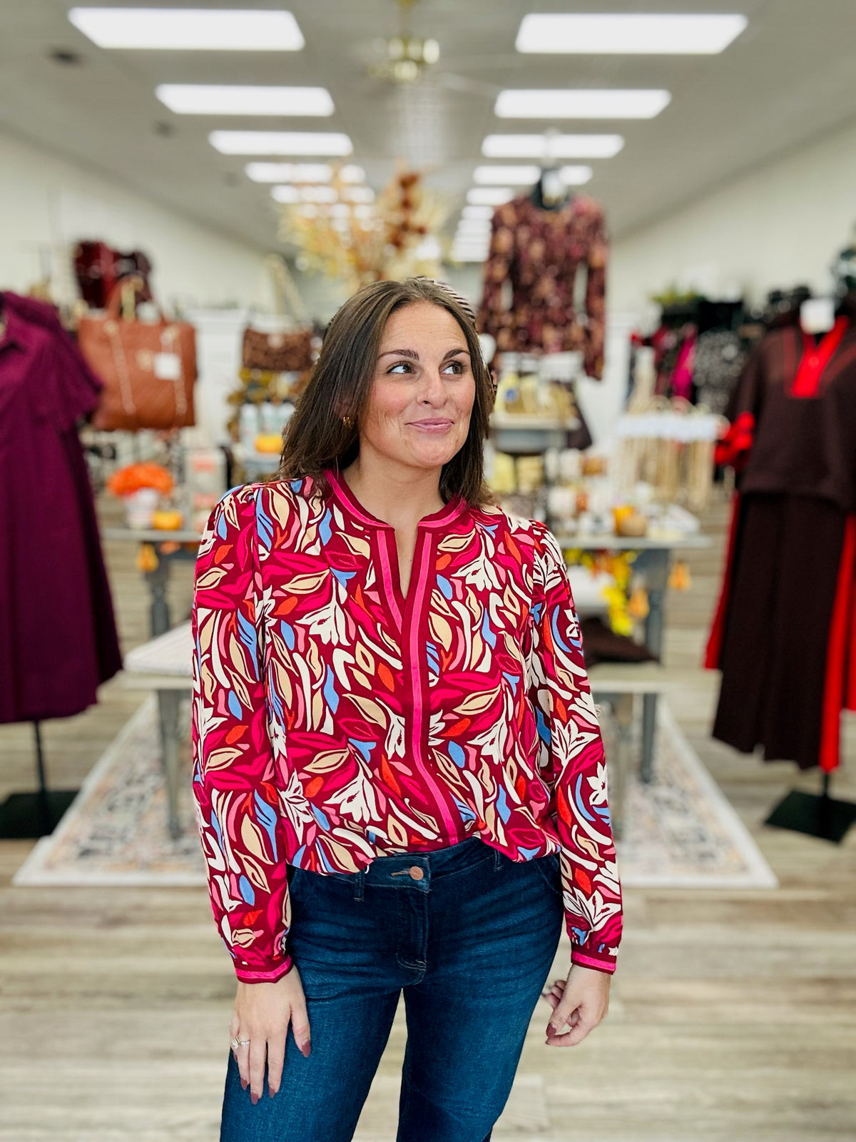 Painted Petals Top — A vibrant floral top featuring rich burgundy, pink, blue, and warm neutral tones