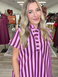 Raspberry Rush Dress – bold pink and burgundy striped dress featuring a relaxed silhouette, collared neckline, and chic gold button detailing.