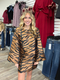 The Wildly chic set tiger print two -piece Set - featuring a warm caramel and black pattern, a relaxed long-sleeve top, and matching skirt