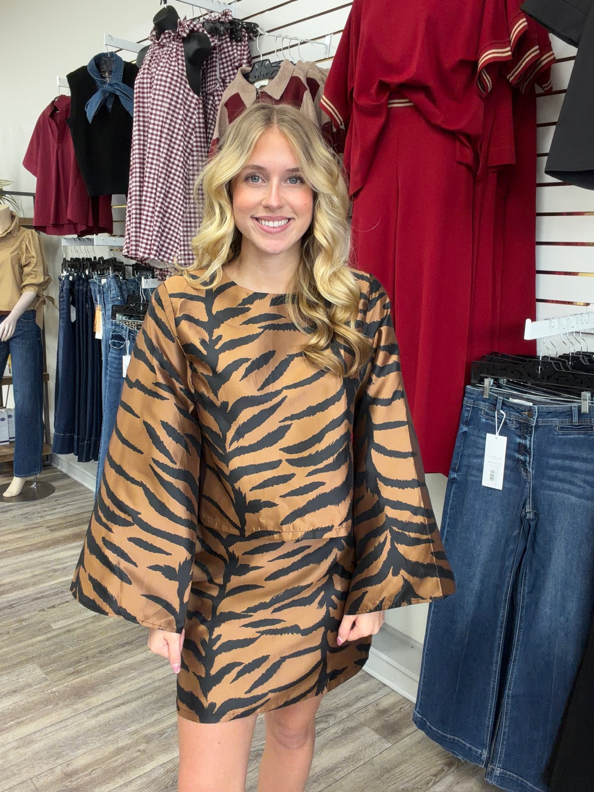 The Wildly chic set tiger print two -piece Set - featuring a warm caramel and black pattern, a relaxed long-sleeve top, and matching skirt
