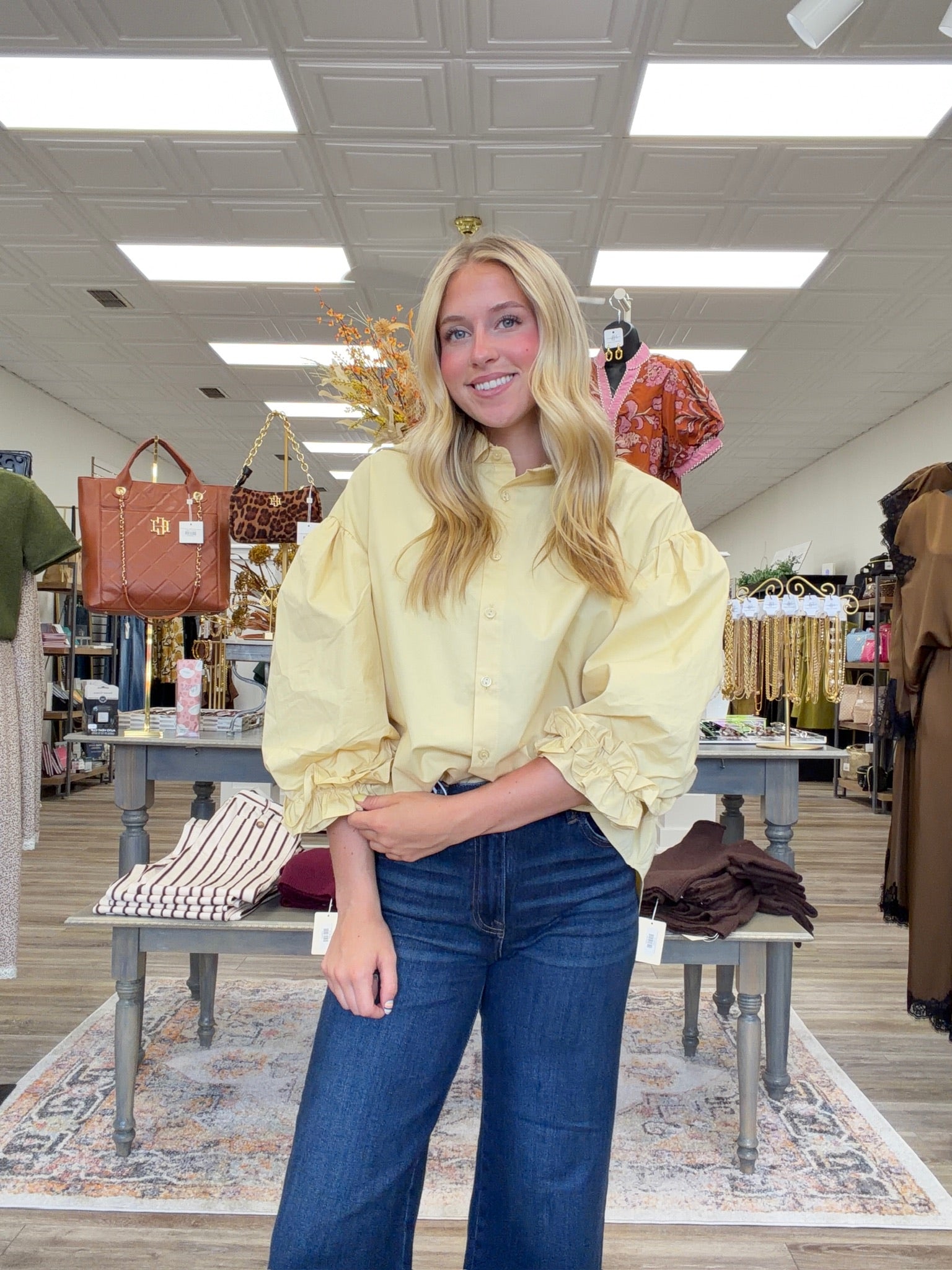 The Eloise blouse - a butter-yellow button-front blouse featuring an oversized collar, dramatic balloon sleeves, and gathered ruffle cuffs.