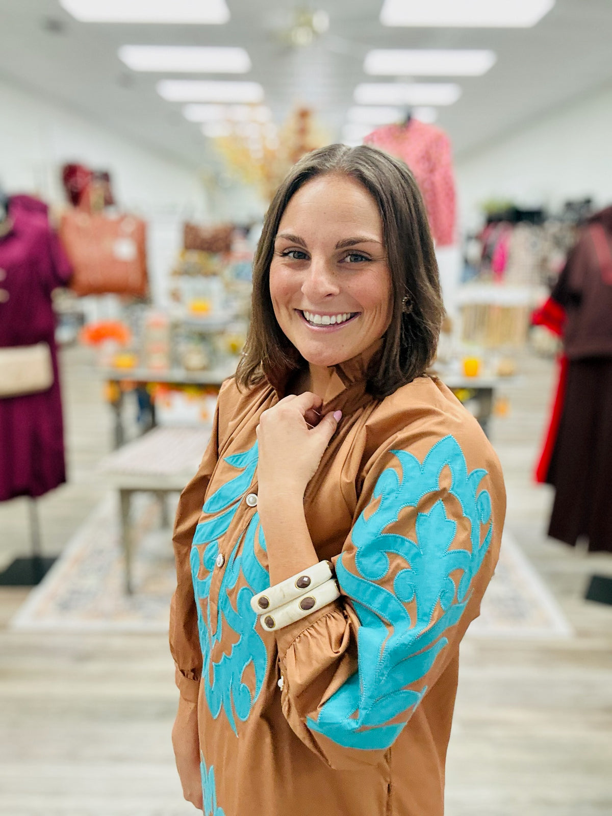 The Jolene dress - This camel-brown dress features beautiful turquoise appliqué detailing on the front, 3:4 sleeve