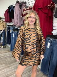 The Wildly chic set tiger print two -piece Set - featuring a warm caramel and black pattern, a relaxed long-sleeve top, and matching skirt