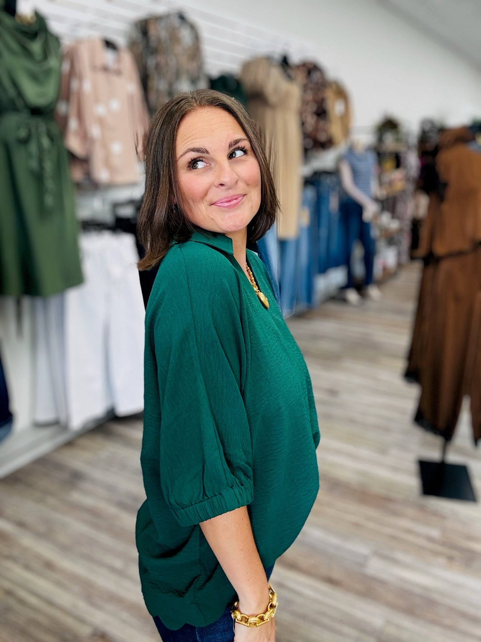 The Harper Top -a hunter green  relaxed oversized blouse infeaturing a split V-neck collar, flowy short sleeves, and a scalloped bottom hem