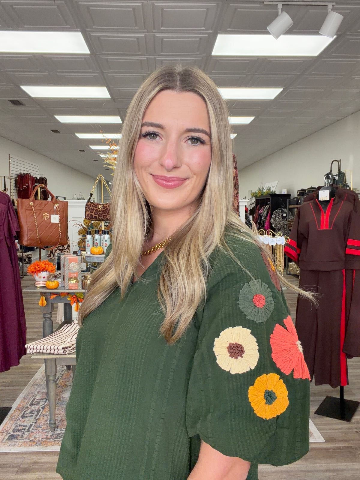 Fall meadow top - rich forest-green textured top featuring statement puff sleeves adorned with colorful dimensional floral details