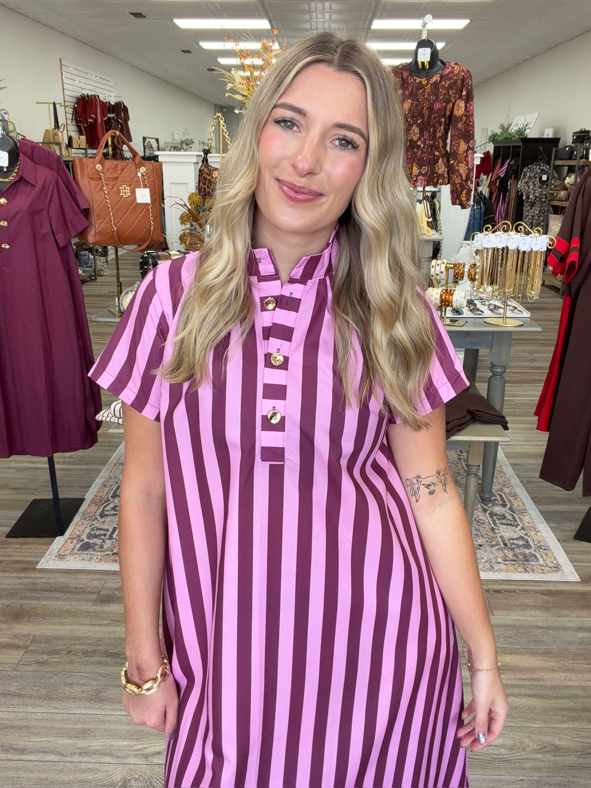 Raspberry Rush Dress – bold pink and burgundy striped dress featuring a relaxed silhouette, collared neckline, and chic gold button detailing.