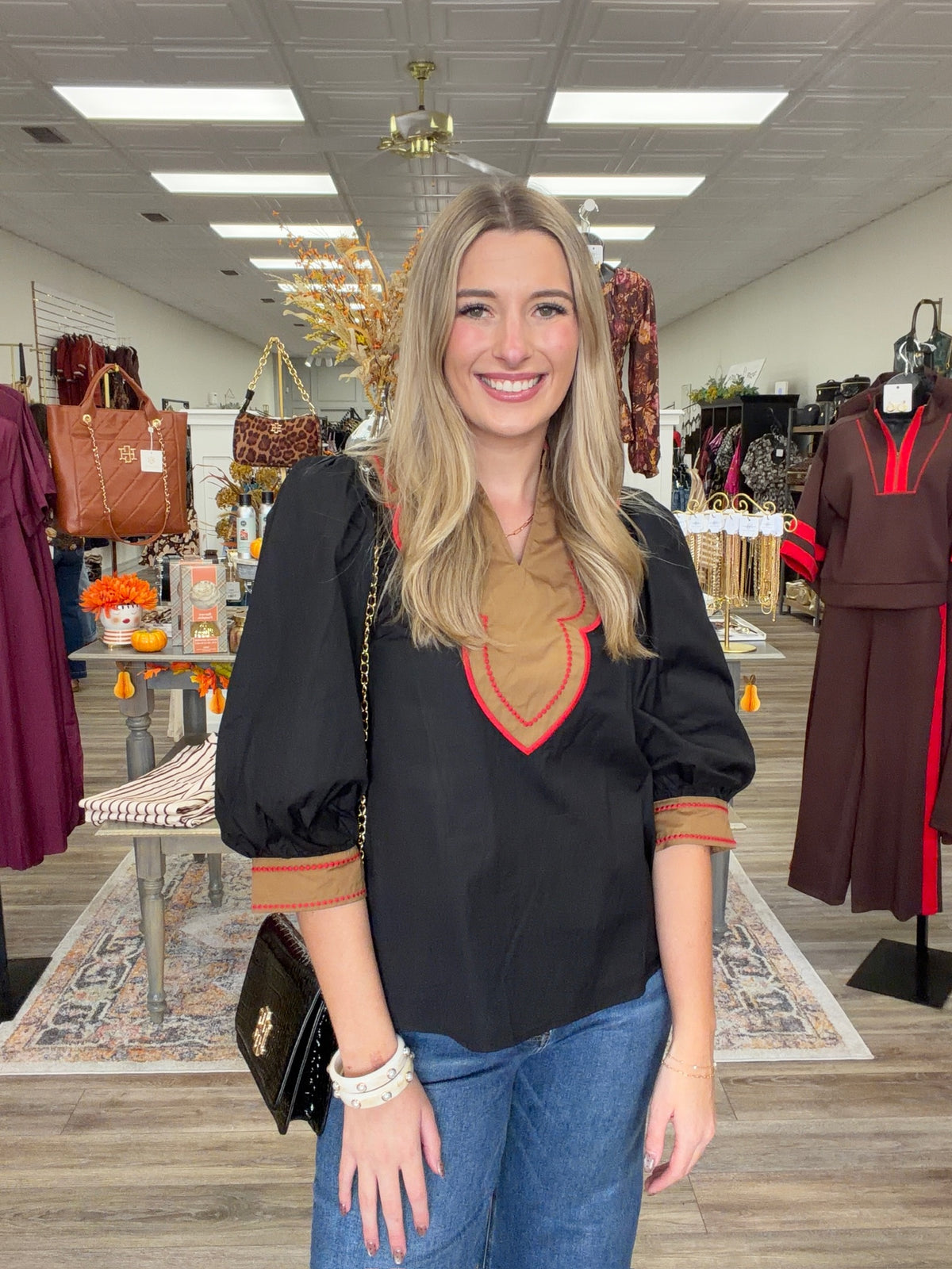 Saddle & Scarlet Blouse - chic black puff-sleeve top featuring a camel scalloped bib collar with vibrant red embroidered trim and matching statement cuffs
