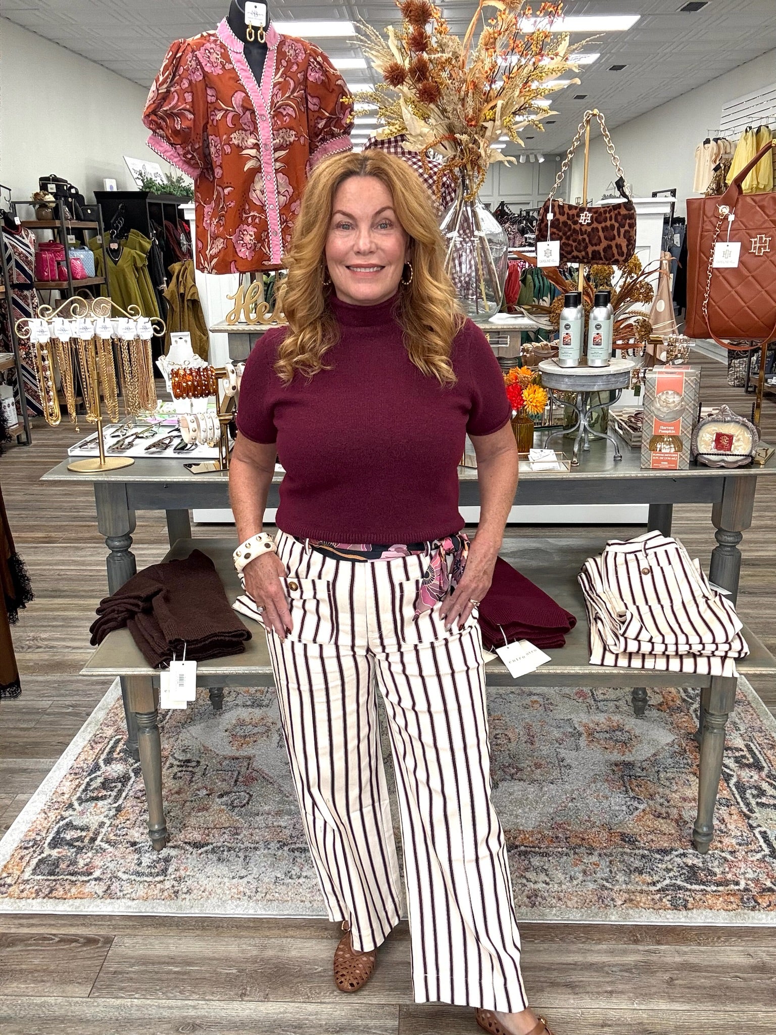The portside pant - Cream cropped pants with thin burgundy stripes, a high-rise fit, and oversized button-detail front pockets