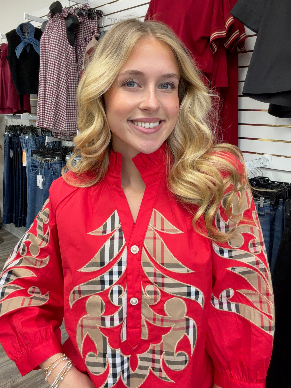 Crimson Plaid Statement Blouse - vibrant red long-sleeve blouse featuring bold plaid appliqué embroidery, a ruffled collar, and button-front detailing