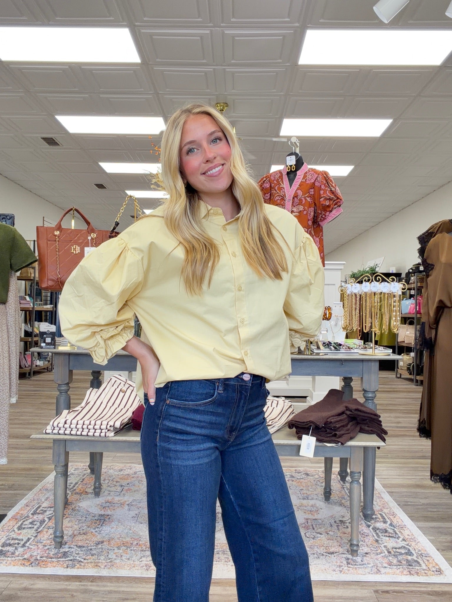 The Eloise blouse - a butter-yellow button-front blouse featuring an oversized collar, dramatic balloon sleeves, and gathered ruffle cuffs.